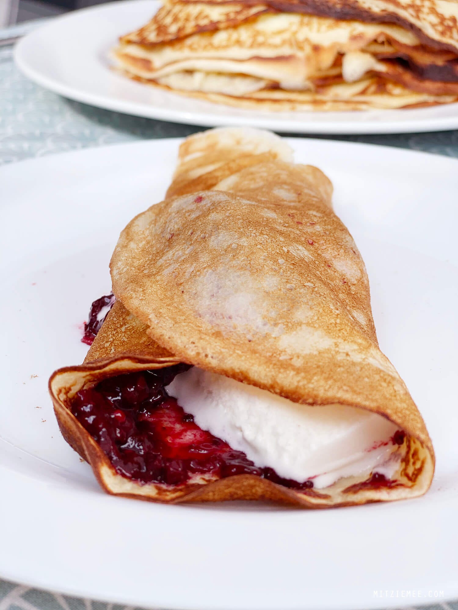 Danish crepes, pandekager, with blackberry jam and vanilla ice cream